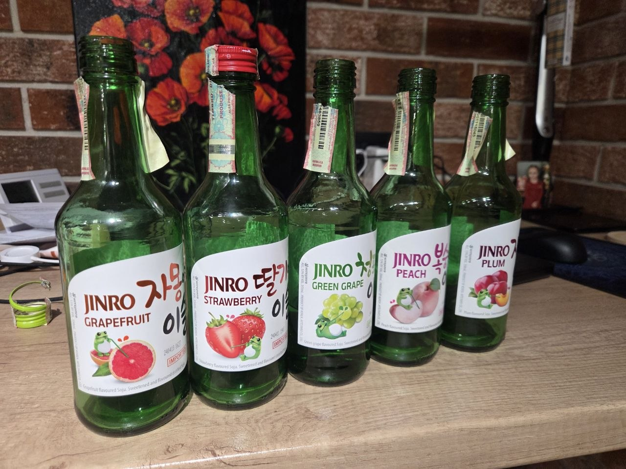 Five bottles of Jinro soju — grapefruit, strawberry, green grape, peach, plum